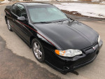 2004 Chevrolet Monte Carlo SS Intimidator edition, black exterior, parked on a road, excellent condition
