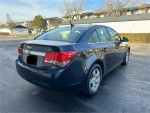 2014 Chevrolet Cruze 1LT sedan showing rear view, well maintained with clean body and good tires.