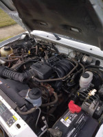 Engine compartment of a 2010 Ford Ranger with low mileage and clean features for sale.