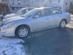 2010 Nissan Altima parked, 66,000 miles, well-maintained with sunroof and new tires, ready for sale.