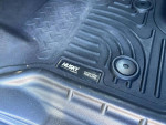 Close-up of Husky liners in a Ford F350 truck before sale, showcasing durability and quality.