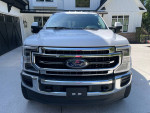 Front view of a 2021 Ford F350 Super Duty Lariat pickup truck in pristine condition, showcasing its features.