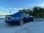 2003 Lexus IS 300 RWD in blue parked by the water with Enkei wheels and lowered suspension