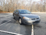2009 Chevrolet Impala LS in excellent condition, parked in an empty lot, showcasing its sleek design.