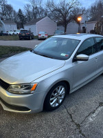2011 Volkswagen Jetta in silver with 130,000 miles, showing minor exterior dings and scratches.