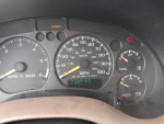 Dashboard of a 1999 Chevrolet TrailBlazer showing speedometer and warning lights.