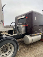 Rear view of a 1996 Peterbilt 379 truck showcasing its extended hood and newly updated components.