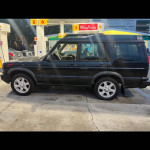 2004 Land Rover Discovery 2 parked at a gas station with a clean appearance, potential trade for reliable vehicle.