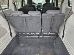 Interior view of 2008 Dodge Caravan showing rear seating area and clean carpet.