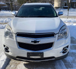 Front view of a 2015 Chevrolet Equinox LTZ FWD in snow, showcasing chrome details and modern design.