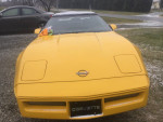 Front view of a yellow 1989 Corvette convertible with a clean finish, ready for sale.