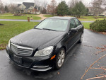2013 black Mercedes-Benz C300 4matic parked, well maintained with 195,000 miles and clean title.