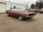1970 Dodge Challenger convertible parked outdoors, needing restoration and repairs, with visible body wear.