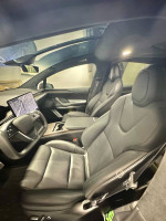 Interior view of a 2023 Tesla X with premium leather seats and a sleek dashboard