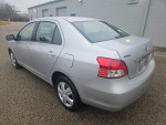 2009 Toyota Yaris in great condition, silver exterior, parked on a gravel surface.