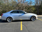 2019 Cadillac CTS Luxury AWD in excellent condition, parked in a lot with trees in the background.