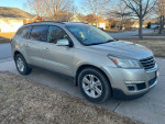2013 Chevrolet Traverse LT AWD parked in driveway, showcasing a silver exterior and good condition.