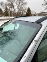 Close-up view of a 2009 Hyundai SantaFe showing the roof and windshield area with some paint wear.