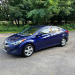 2011 Hyundai Elantra GLS in blue color parked on a road, showcasing its front and side view