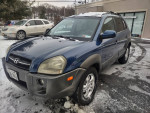 2005 Hyundai Tucson 4x4 parked in snowy area, featuring Bluetooth stereo and backup camera.