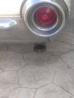 Close-up of a shiny exhaust pipe with a red tip on a classic Ford Thunderbird