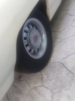 Close-up of a Ford Thunderbird wheel showing new tires and vintage rim design.