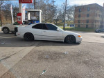 1994 Honda Accord coupe parked at a gas station, featuring aftermarket parts and a project car aesthetic.