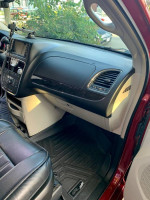 Interior view of a 2014 Chrysler Town & Country with black leather seats and dashboard.