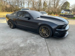 2013 Ford Mustang GT Premium in matte finish with upgraded wheels parked outdoors