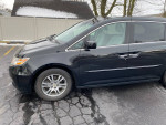 2011 Honda Odyssey EX FWD in black, parked with power sliding doors and well-maintained exterior.