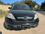 Front view of a 2007 Honda CR-V EX FWD in black, showcasing its rugged design and compact SUV features.