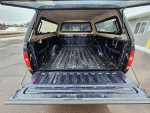 Interior view of a 2002 Ford F-150 truck bed, showing clean and well-maintained space.