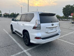 2020 Lexus GX 460 4WD in pearl white parked, showcasing its sleek design and clean condition with new tires.