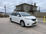 2011 Toyota Sienna LE AWD parked on a scenic road, well maintained with new brakes and premium wheels.