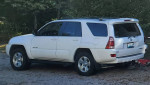 2005 Toyota 4Runner SR5 4WD parked with a tow package, showcasing a white exterior and alloy wheels.