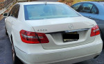 2010 Mercedes-Benz E-Class E350 luxury sedan in white, showcasing rear design and taillights.