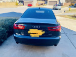 Rear view of a 2012 Audi A6 Premium Plus 2.0, parked in a residential area.