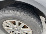 Close-up of the wheel and tire of a 2008 Volvo XC90 showing tread and condition.