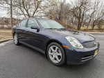 2004 Infiniti G35 AWD sedan in clean condition with low mileage of 123,000 miles parked on the street.