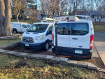Two 2017 Ford Transit 250 cargo vans parked side by side, showcasing their well-maintained condition.