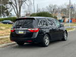 2013 Honda Odyssey EX FWD black minivan parked on street, very clean and well-maintained.