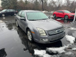 2007 Ford Fusion SEL V6 in decent condition parked outdoors, showing some dents and rust.