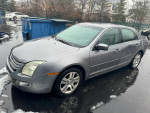 2007 Ford Fusion SEL FWD in decent condition, V6 engine, aftermarket radio, and visible dents