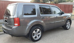 2012 Honda Pilot EX FWD parked on street, showcasing its gray exterior and chrome wheels.