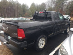 2015 Ram 1500 truck with turbo diesel engine parked, featuring backrack and tonneau cover in good condition.