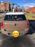 Rear view of a 2012 MINI Cooper, well-maintained with a smiley face, ready for sale.