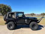 2006 Jeep Wrangler with 4.0L engine and 4" lift, featuring aftermarket fenders and new soft top.
