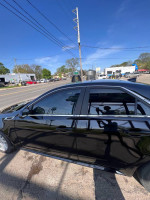 2011 Cadillac CTS all-wheel drive in black with tinted windows, captured on a sunny day.