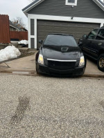 Black 2011 Cadillac CTS parked in driveway with clean exterior and new brakes, available for $7300.