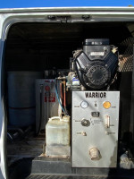 Interior view of a 2004 Ford E-250 van with truckmount carpet cleaning system and accessories